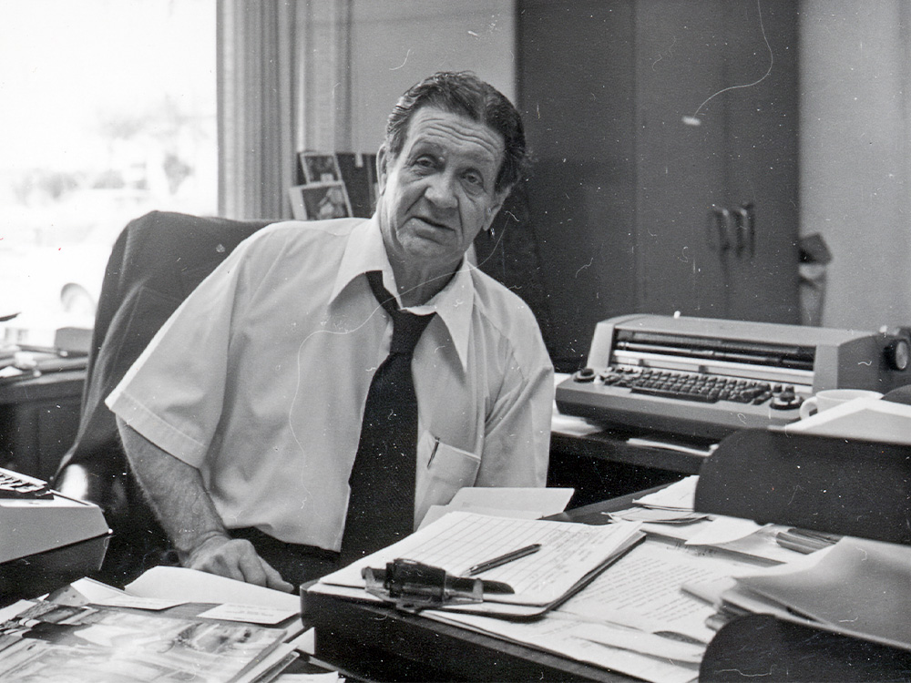 Photo of Alfred T. Mitchell at his desk in Founders Building