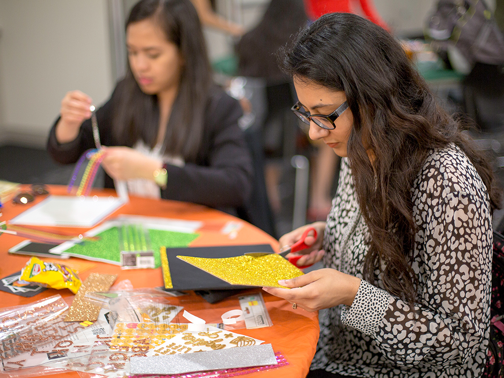 Nida Nasir cuts sparkly gold paper with scissors