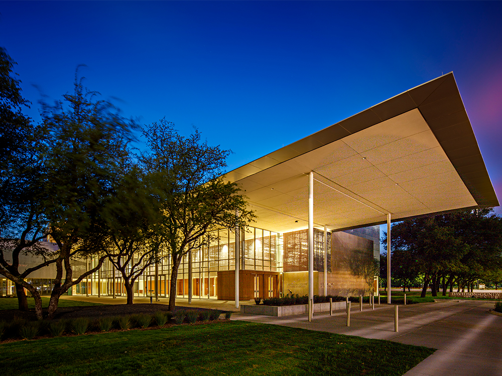 The sun sets behind the alumni center