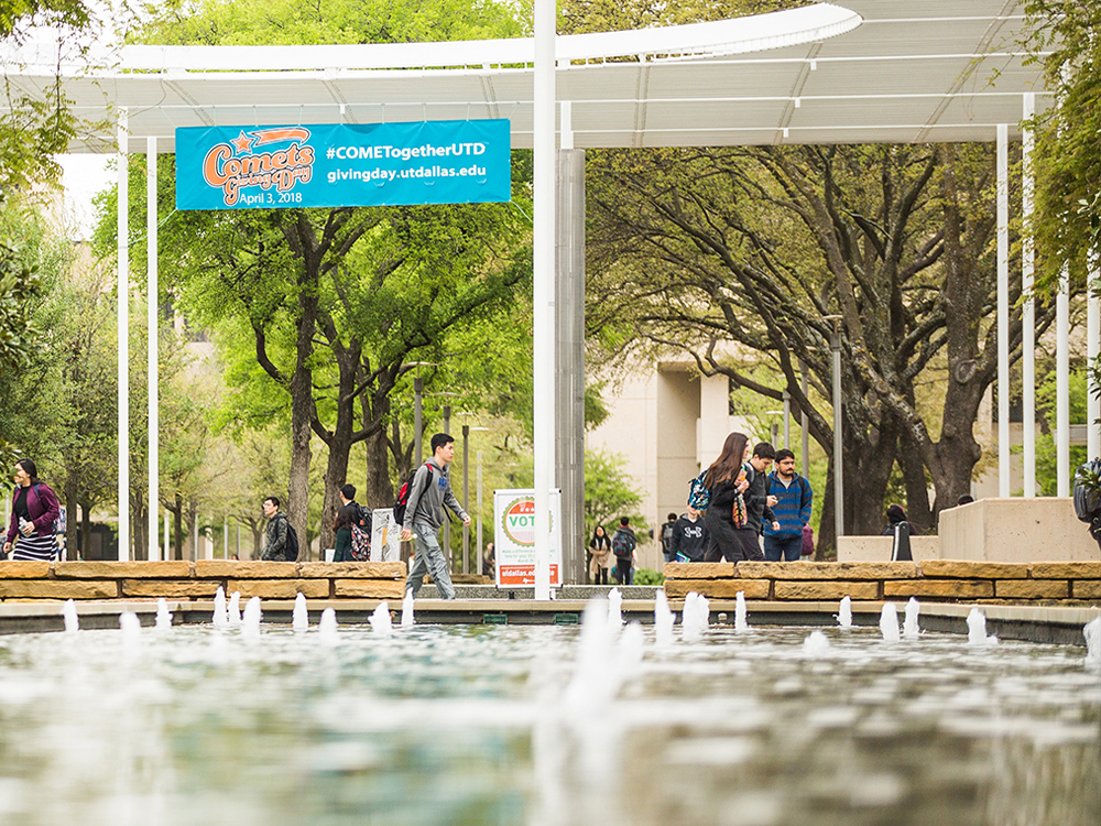 Students walking near reflecting pool